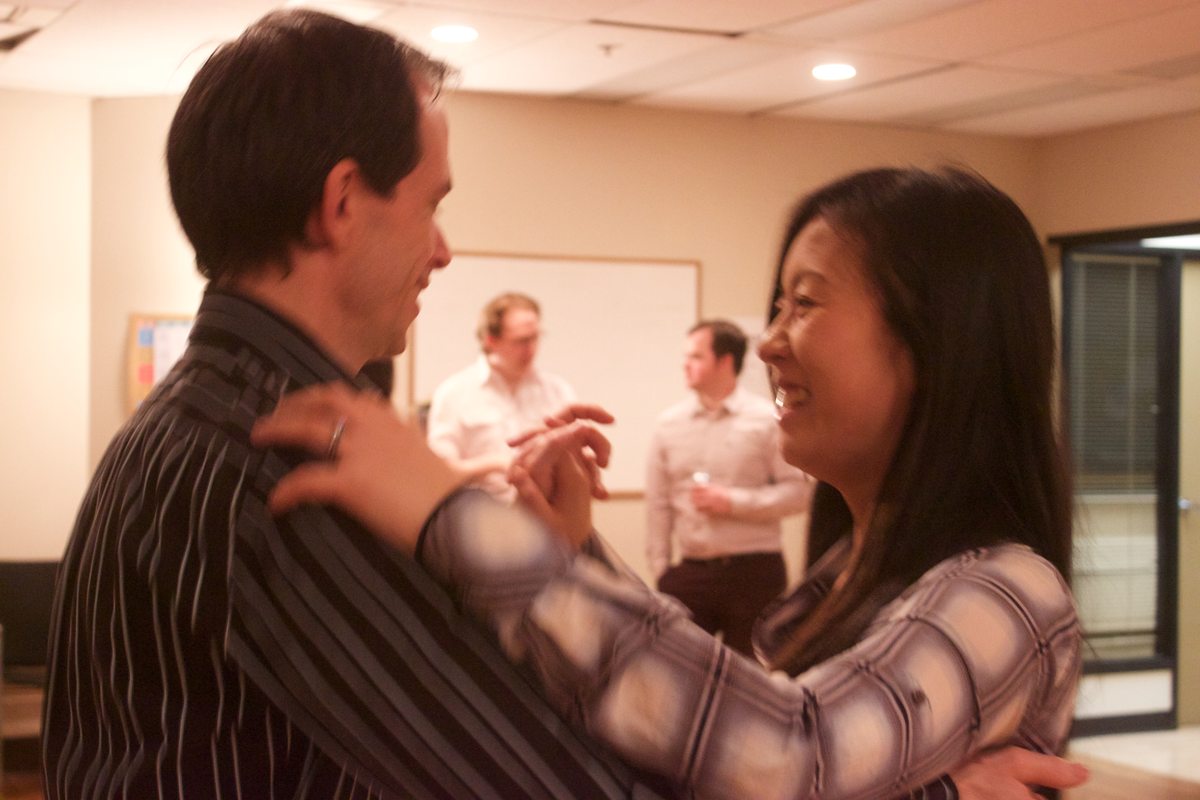 Two partners smiling while practicing a dance hold