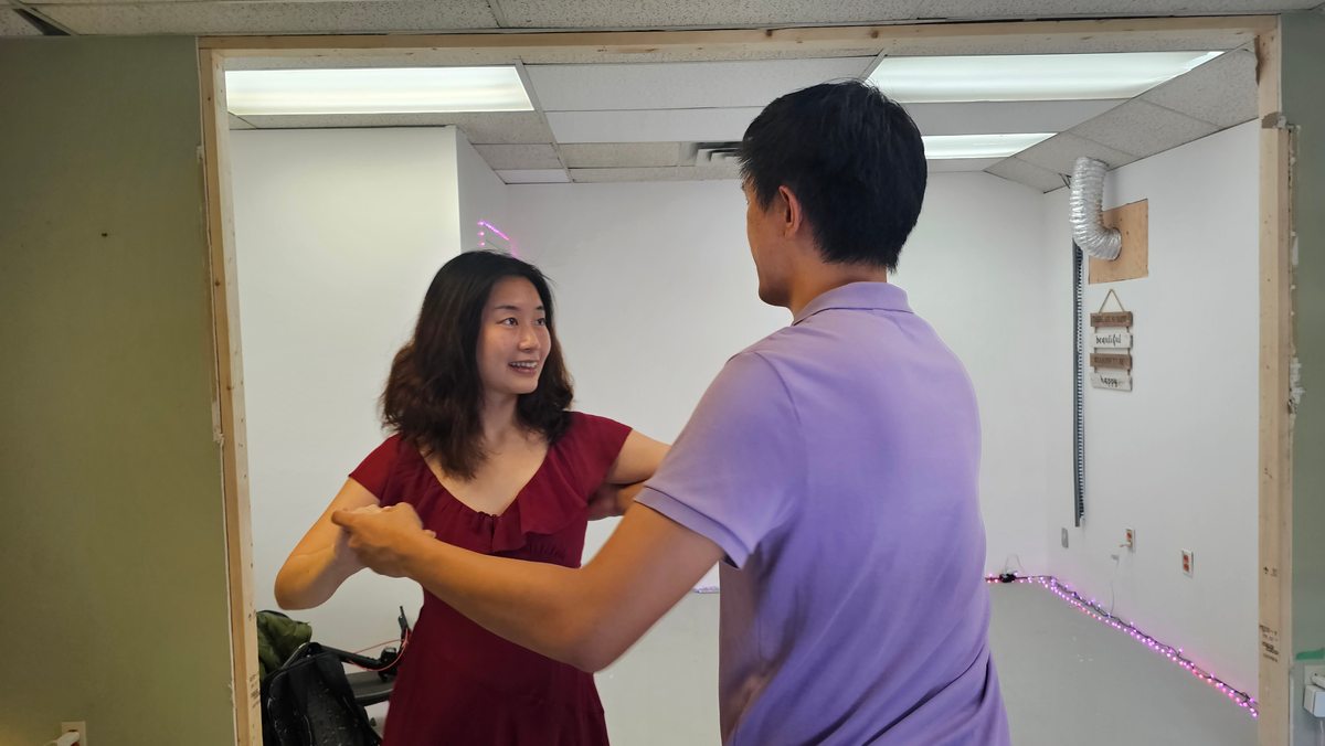 Two partners practicing a dance hold in the studio
