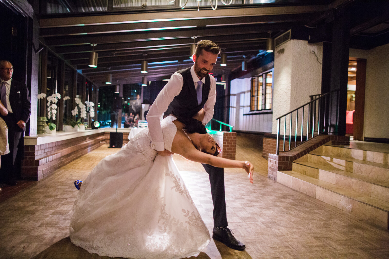 Wedding couple moving together through a supported dip