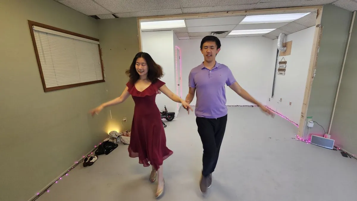 Partners stepping forward together with their arms extended