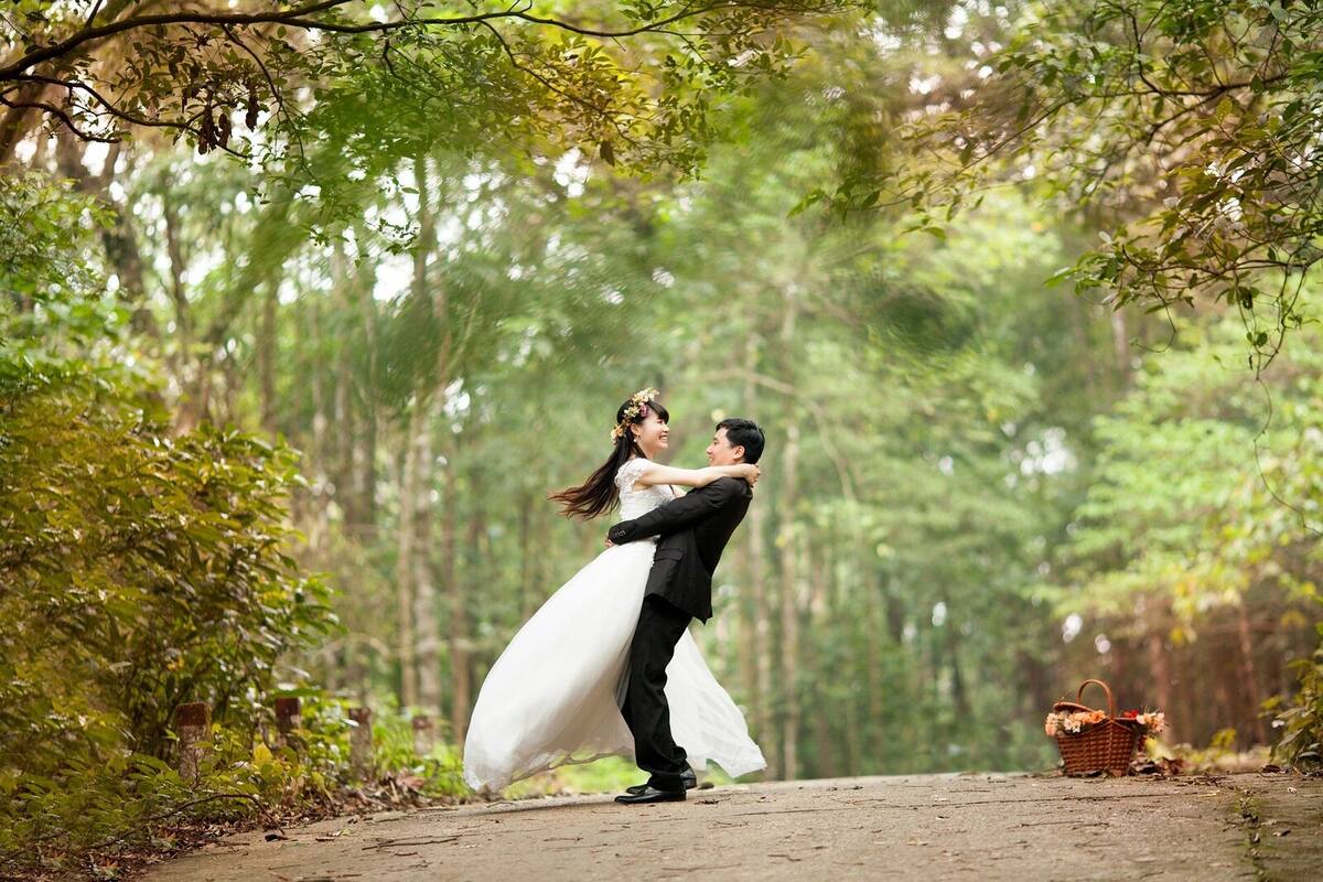 Romantic wedding couple sharing a dance pose outdoors