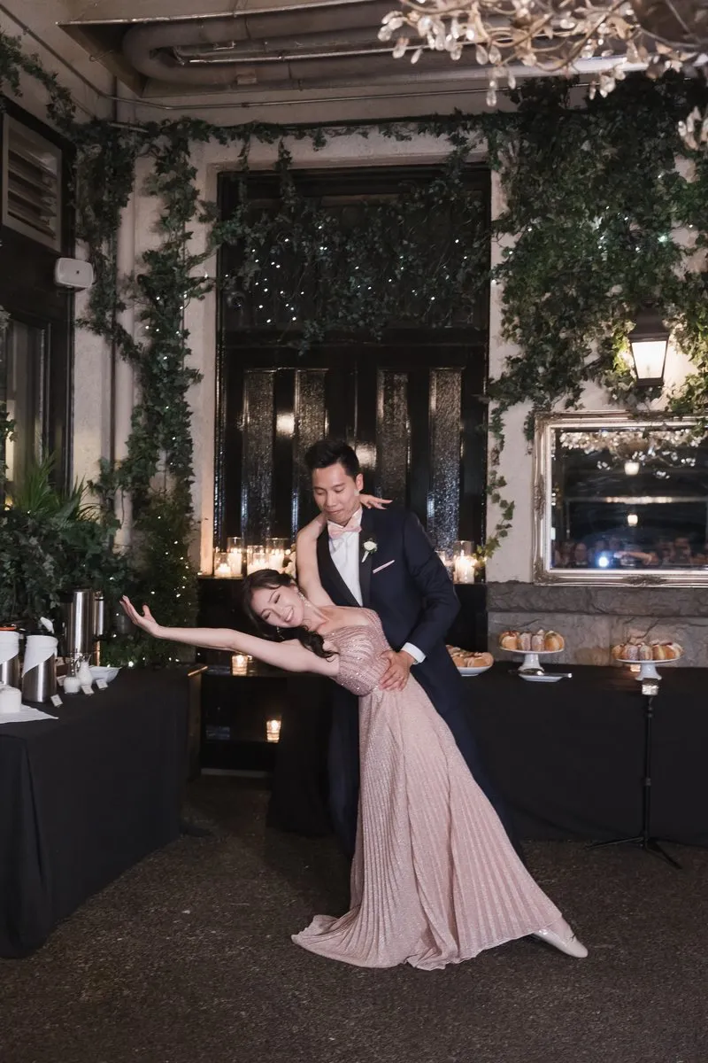 A couple dancing a dip, with the woman in a pink dress