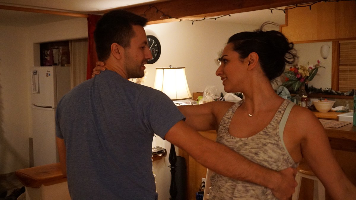 Two partners practising a dance hold together