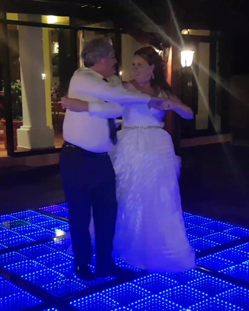 Wedding couple smiling at each other while dancing at their reception