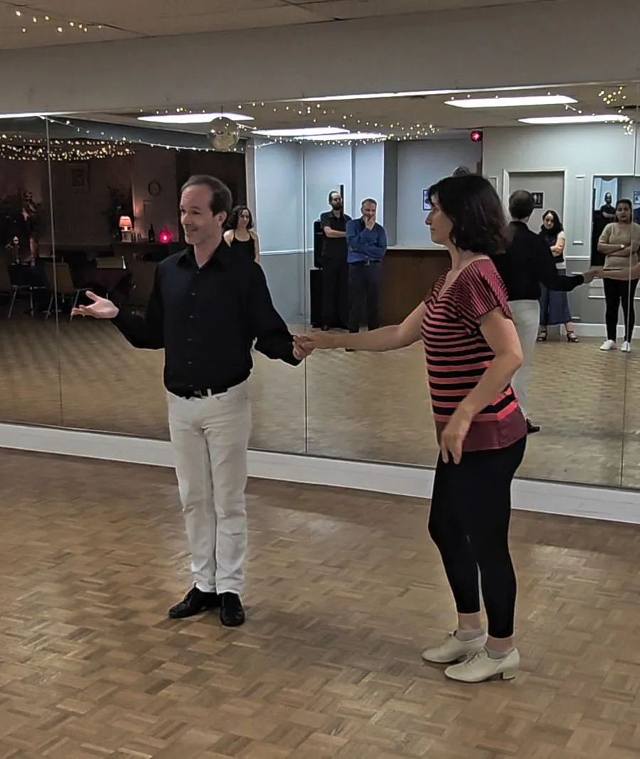 Two partners practicing together during a dance class
